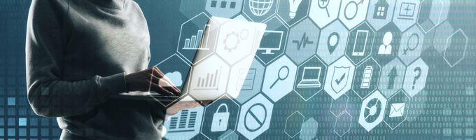 A nonidentifiable person trying to hack into a laptop