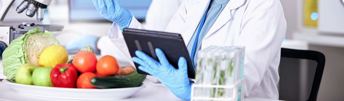 A person in a lab testing food